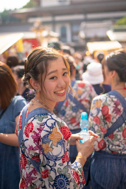 istock Young woman in matsuri costume looking over shoulder 1001776620