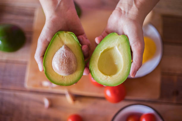 istock Guacamole making, halved avocado close-up 1001776628