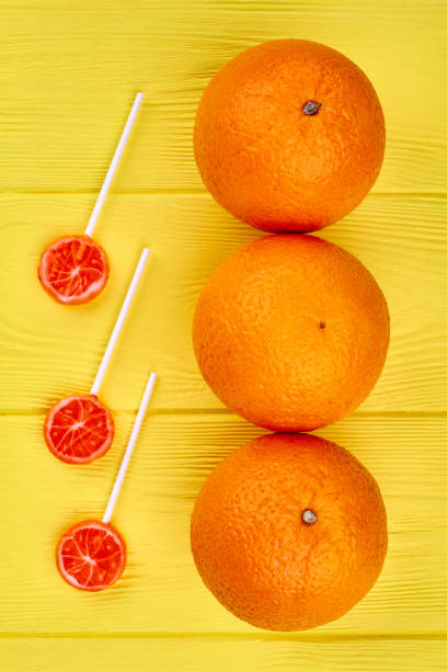istock Row of fresh oranges and lollipops. 1001781026