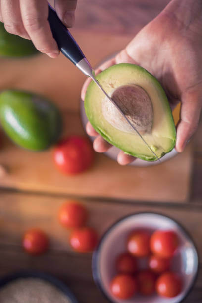 istock Guacamole making, halved avocado close-up 1001781730