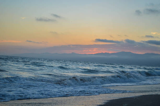 Waves crashing at sunset at Venice pier and beach in Venice/Marina del Rey, CA