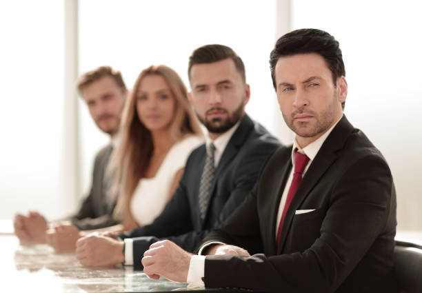 istock business group sitting at the negotiating table 1001786458