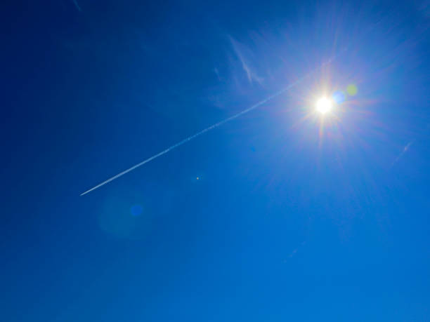 istock Bright sun with flares and spectral aureole around against blue sky 1001786604