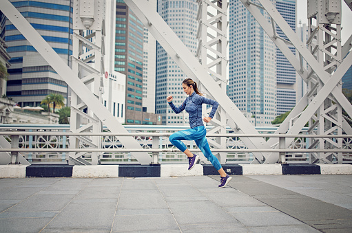 Runner girl is sprinting in the city
