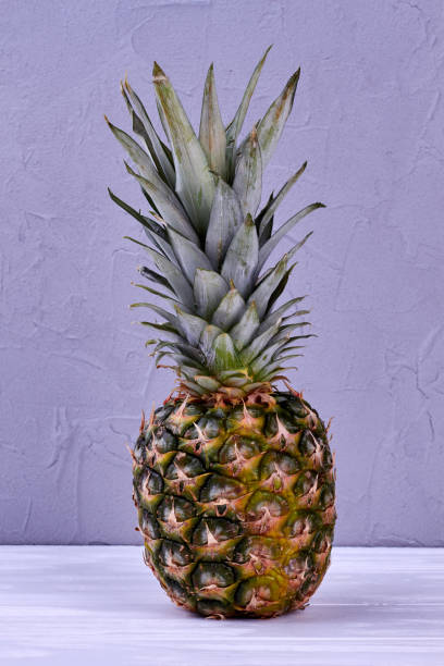 istock Fresh pineapple on wooden background. 1001793700
