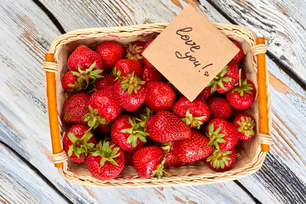 istock Basket of fresh strawberries on wooden surface. 1001811518