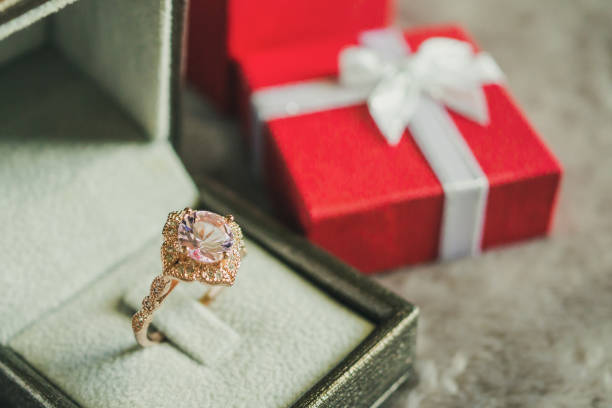 istock jewelry pink diamond ring with red gift box background 1001814356