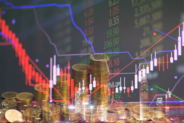 istock Double exposure of coin stack with stock market screen chart board and candle stick for financial business and investor analysis concept idea. 1001814788