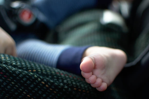 Baby foot place on the edge of car seat Baby foot place on the edge of car seat babyproof stock pictures, royalty-free photos & images