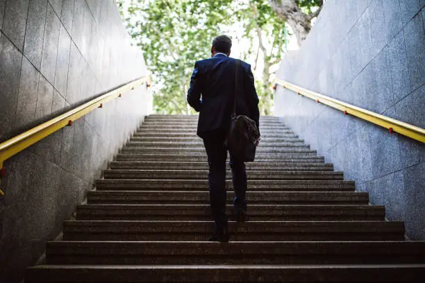 Pedestrian Businessman Walking Out Of Metro Up Stairs On Sunny Morning
