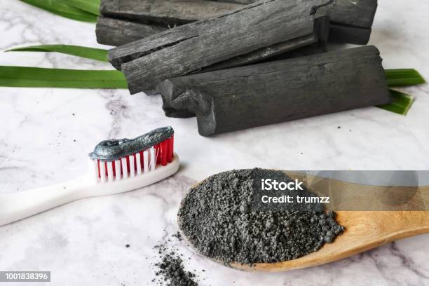 Toothpaste By Activated Charcoal Powder On Marble Table Stock Photo - Download Image Now