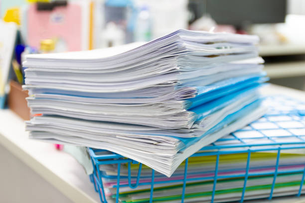 istock file folder and Stack of business report paper file on the table in a work office 1001851526