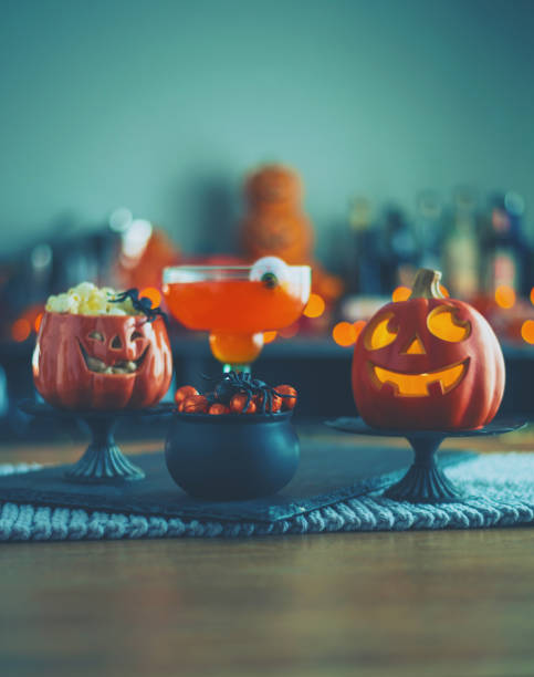 istock Halloween time. Vibrant colored drinks with cauldron of candy 1001912158