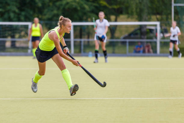 Young hockey player woman with ball in attack Young hockey player woman with ball in attack playing field hockey game team sport stock pictures, royalty-free photos & images
