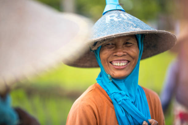 istock Indonesian women laughing on the rice field 1001920374