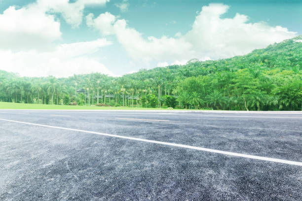 istock Asphalt pavement under blue sky and white clouds, background road materials for automobile advertising 1001923312