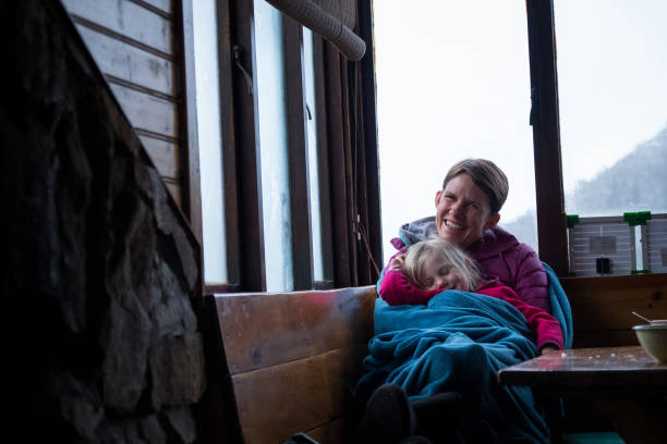 istock Mother and daughter wrapped in a warm blanket 1001943912