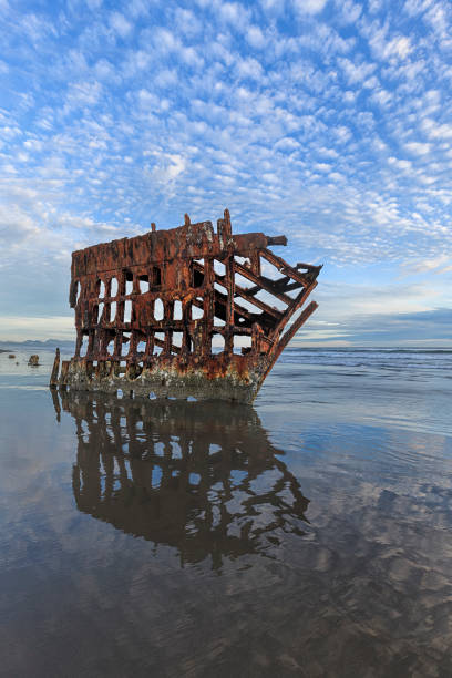 istock Refelction of shipwreck and sky in Oregon. 1001948588