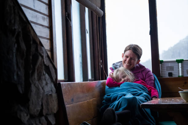 istock Mother and daughter wrapped in a warm blanket 1001953116