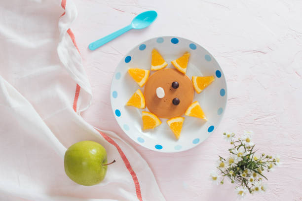 istock Pancakes with fruit for the children. Top view 1001955856