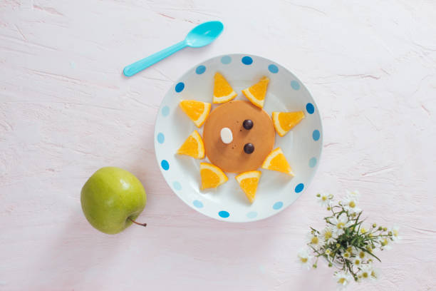 istock Pancakes with fruit for the children. Top view 1001955858
