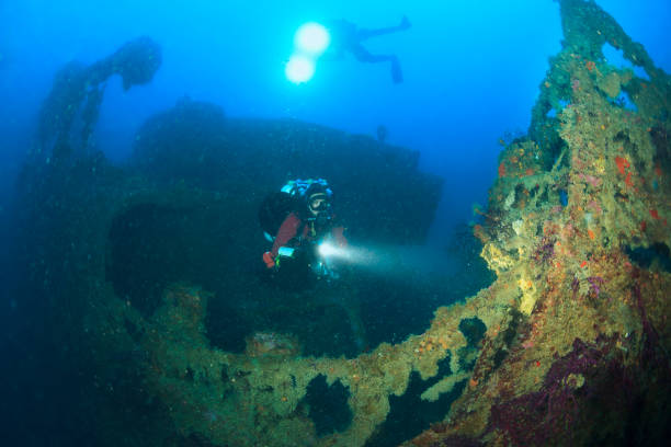 istock Technical Diving Scuba diver Exploring and enjoying Wreck diving over a shipwreck  Sea life  Diving couple  Water sports  Techdive Scuba diver point of view 1001966762