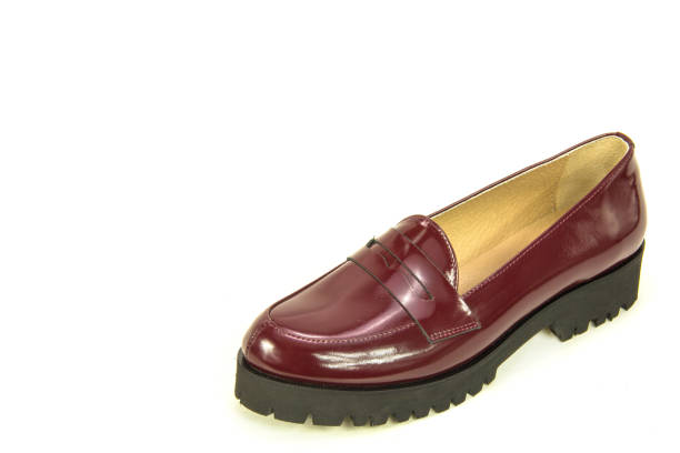 istock One burgundy leather woman's shoe (loafer) on a white background with copy space. Modern shoes 1001966796