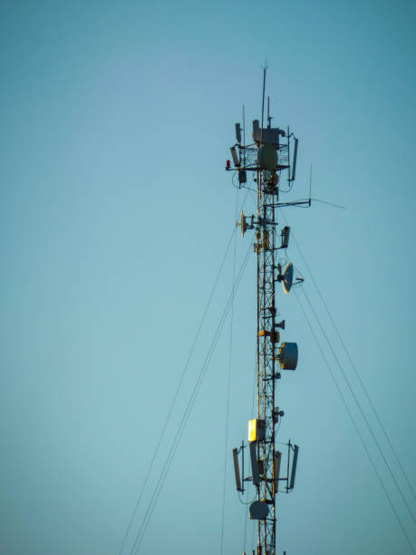 istock Radio and telephone antenna, technology and transmission, and a beautiful cloudless blue sky. Portrait 1001969480