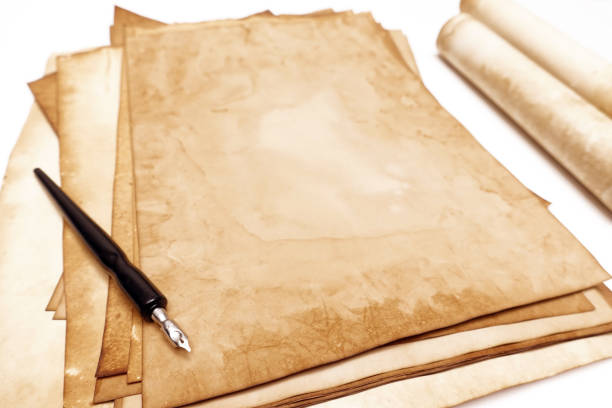 istock old paper on brown wood texture with pen 1001977418