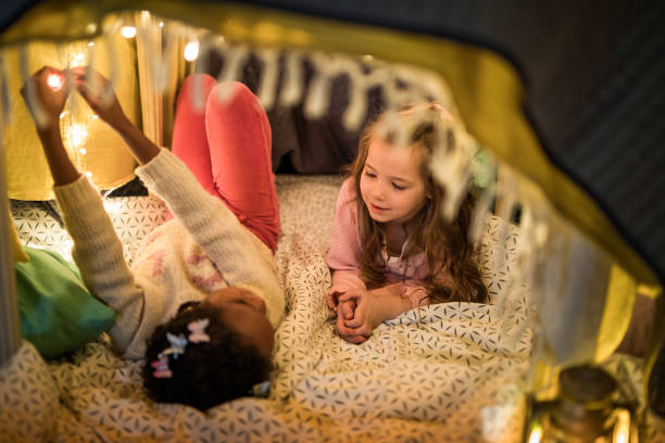 istock Small friends communicating while relaxing in a tent at home. 1001984438