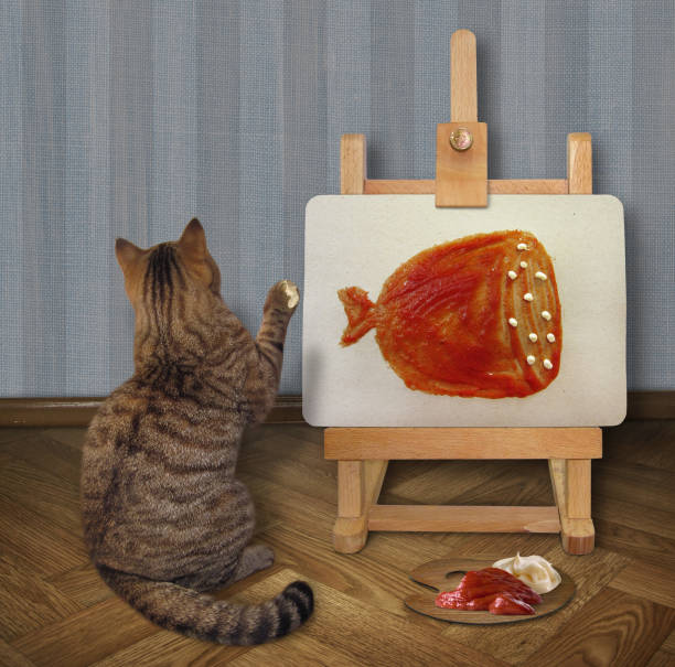 istock Cat draws a picture on the easel 3 1001987012
