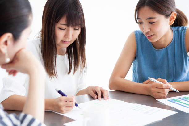 istock A woman writing on paper. 1001989812