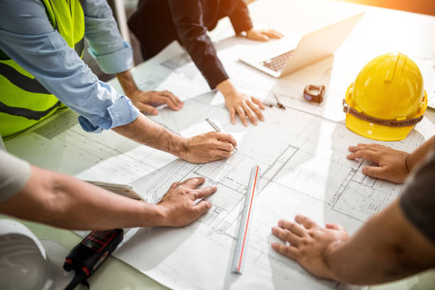 Team Engineer drawing graphic planning Team Engineer drawing graphic planning of interior creation project cooperating with talented teacher giving advice, working concept. construction stock pictures, royalty-free photos & images