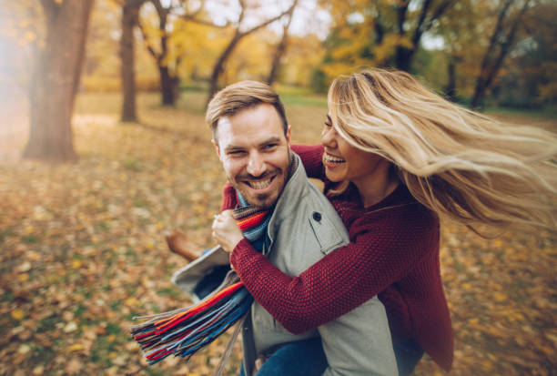 istock Happy couple having fun while piggybacking in autumn day. 1002003718