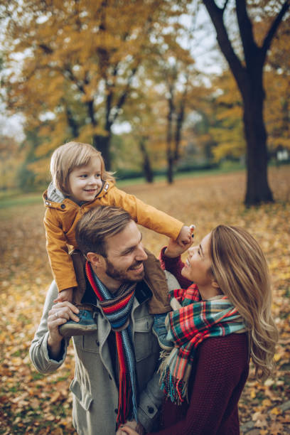 istock Happy parents having fun with their small son in autumn day. 1002007706