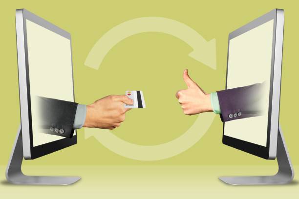 istock exchange credit card for new concept, two hands from computers. hand with credit card and thumbs up, like. 3d illustration 1002013610