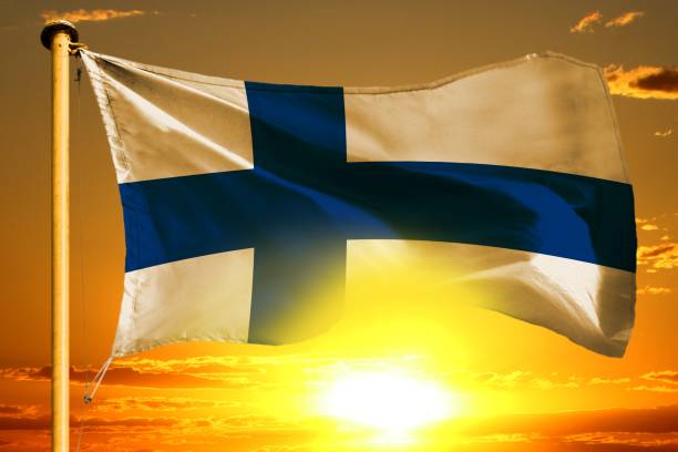 istock Finland flag weaving on the beautiful orange sunset with clouds background 1002013782