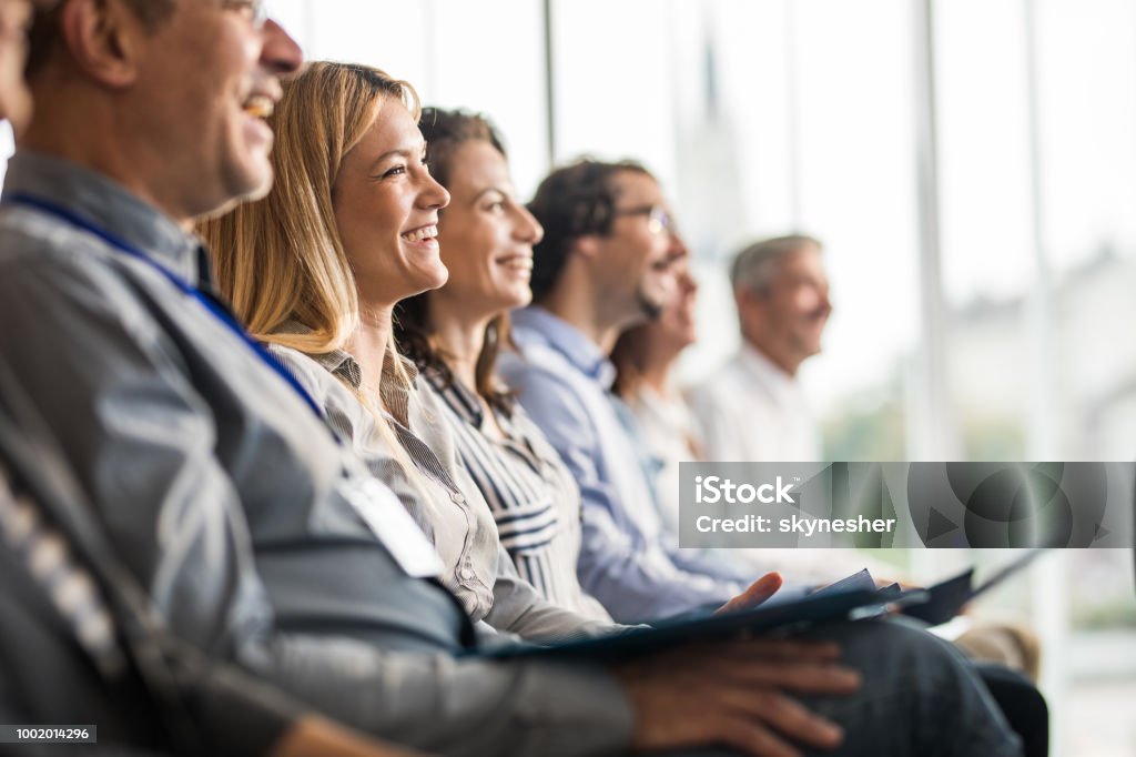 Happy business people in a line on a training class in the office. Large group of happy business people attending a seminar in the office. Seminar Stock Photo