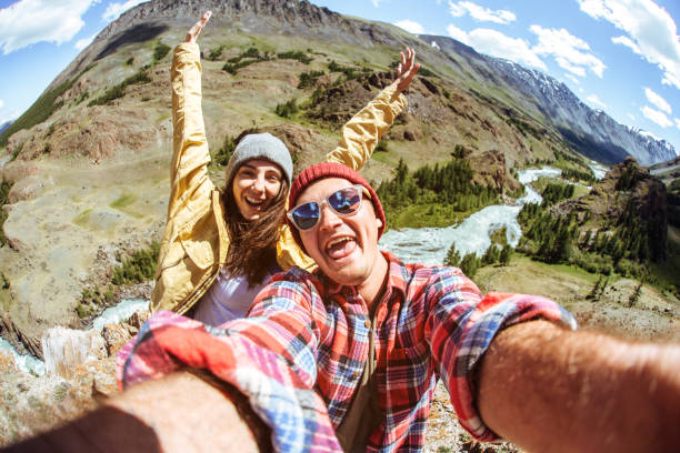 istock Man and female in hiking gear taking a selfie outside 1002017182