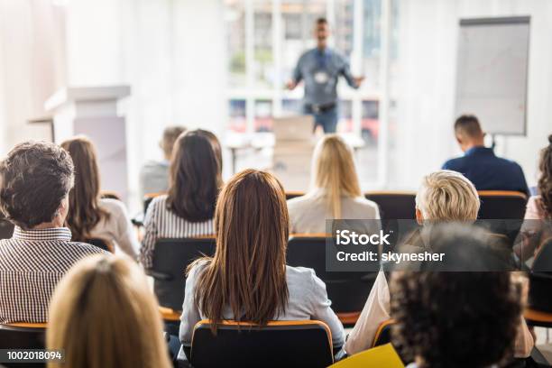Rear View Of Business People Attending A Seminar In Board Room Stock Photo - Download Image Now