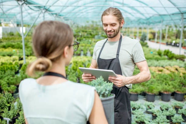 istock Workers supervising plants in the greenhouse 1002018592