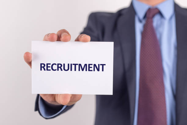 istock Man showing paper with RECRUITMENT text 1002023284