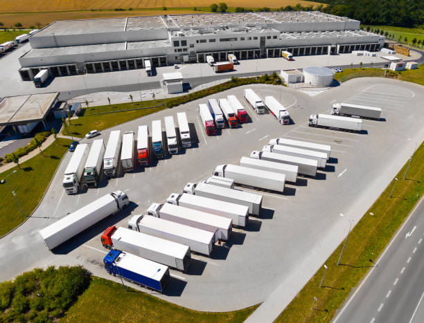 the warehouse with trucks. aerial view to logistics. - distribution warehouse industrial building large building exterior imagens e fotografias de stock