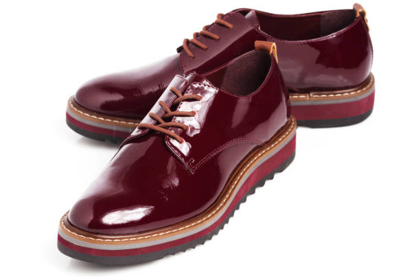 istock Deep red shiny pair of shoes 1002027100