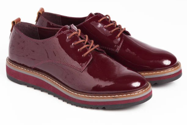 istock Deep red shiny pair of shoes 1002027108