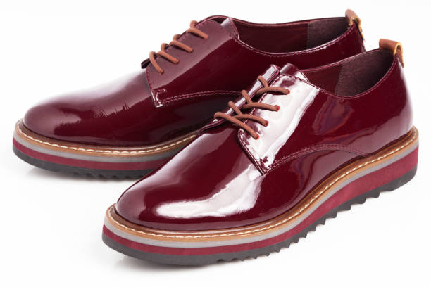 istock Deep red shiny pair of shoes 1002027112