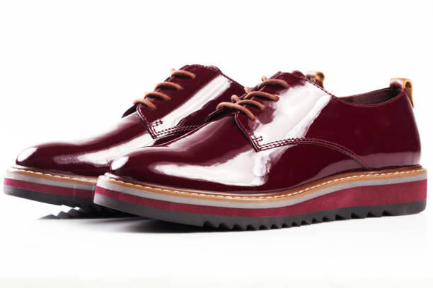 istock Deep red shiny pair of shoes 1002027130