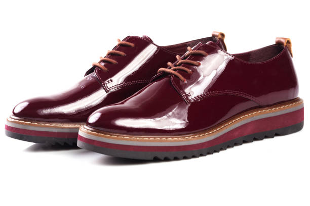 istock Deep red shiny pair of shoes 1002027134
