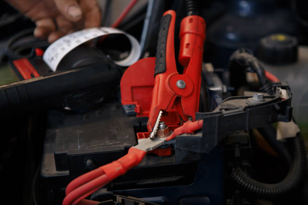 istock Accumulator charging. Hands and terminals. Car repair. Service 1002032938