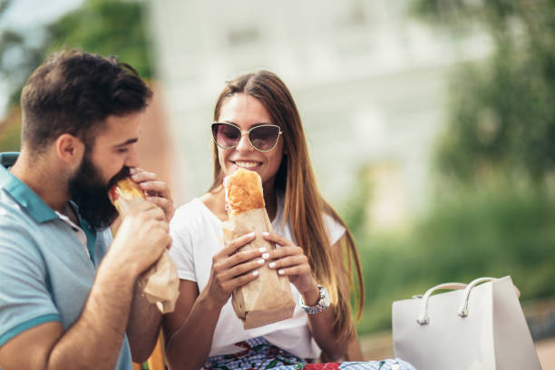 istock Young couple is eating sandwiches and having a great time 1002033364